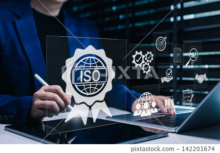 ISO Certification and quality management concept. Businesswoman uses tablet and laptop with ISO certification icons, international standards, compliance, quality management systems, certificate, 142201674