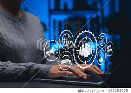 Digital Marketing and Target Audience Strategy Concept. Person using laptop with marketing icons like target audience, email, SEO, social media, representing market planning and customer engagement. Digital Marketing and Target Audience Strategy Concept. Person using laptop with marketing icons like target audience, email, SEO, social media, representing market planning and customer engagement. 142201676