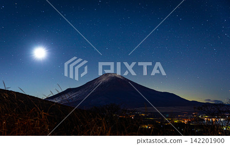 Mount Fuji Beneath Bright Moon and Starry Night Sky in Japan Mount Fuji Beneath Bright Moon and Starry Night Sky in Japan 142201900