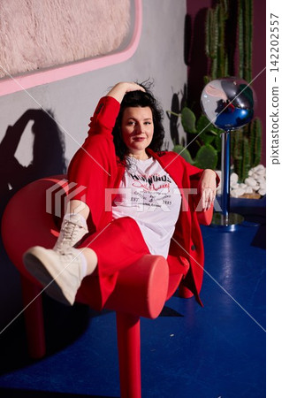 White woman stylist posing with disco globe and cactus White woman stylist posing with disco globe and cactus 142202557