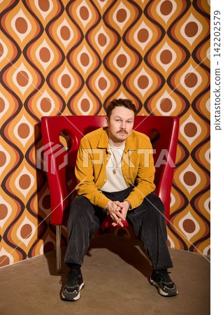 Classy individual sitting in sentimental surroundings reflecting deeply Classy individual sitting in sentimental surroundings reflecting deeply 142202579