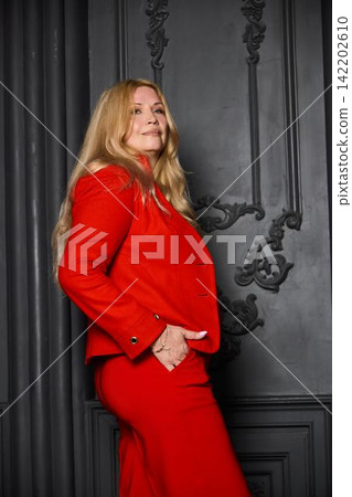 Eloquent woman dressed in red confidently motivates and influences viewers Eloquent woman dressed in red confidently motivates and influences viewers 142202610