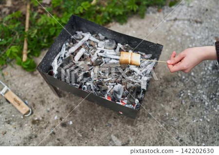 Barbecue setting with glowing embers and casual atmosphere Barbecue setting with glowing embers and casual atmosphere 142202630