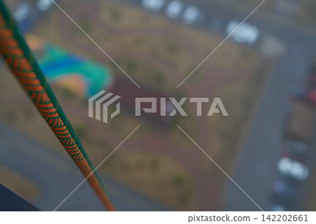 Safety rope anchored on building exterior, maintenance setup Safety rope anchored on building exterior, maintenance setup 142202661