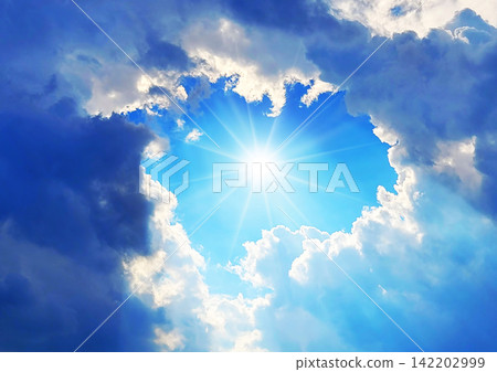 Clouds spread across the blue sky, bathed in sunlight—a refreshing summer sky that evokes a sense of hope. Clouds spread across the blue sky, bathed in sunlight—a refreshing summer sky that evokes a sense of hope. 142202999