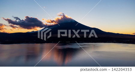 Mount Fuji Silhouette and Dramatic Clouds Reflected at Sunset Mount Fuji Silhouette and Dramatic Clouds Reflected at Sunset 142204353