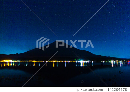 Mount Fuji Centered Beneath a Wide Blue Starry Sky With Lake Reflections Mount Fuji Centered Beneath a Wide Blue Starry Sky With Lake Reflections 142204378