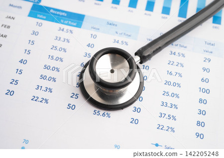 Stethoscope on chart or graph paper, Financial, account, statistics and business data medical health. 142205248
