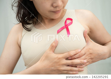Asian woman with pink ribbon for October world breast cancer day. Asian woman with pink ribbon for October world breast cancer day. 142205291