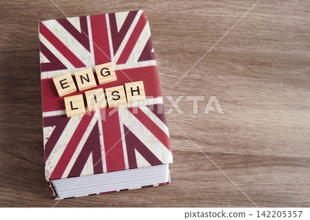 English book with graduate hat, learning and tutorial for foreigner. English book with graduate hat, learning and tutorial for foreigner. 142205357