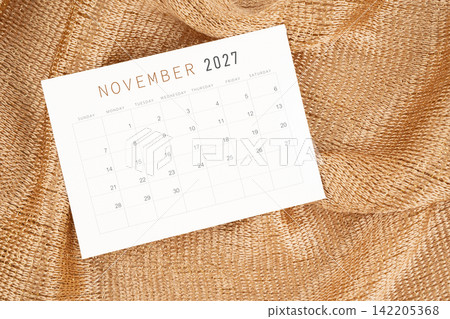 November 2027 calendar card on golden color textile. November 2027 calendar card on golden color textile. 142205368
