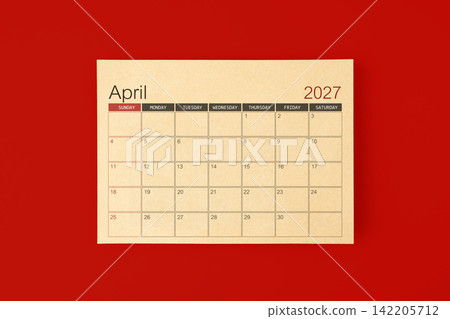 April 2027 desk calendar made from brown paper page on red background. April 2027 desk calendar made from brown paper page on red background. 142205712