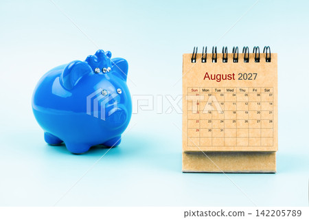 Piggy bank and blank August 2027 calendar, Reminder schedule of savings money concepts. Piggy bank and blank August 2027 calendar, Reminder schedule of savings money concepts. 142205789