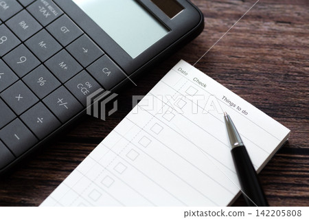 To-do list and black calculator To-do list and black calculator 142205808