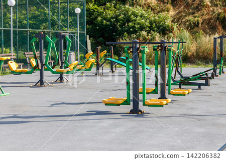 Gym workout equipment or exercise equipment in a park Gym workout equipment or exercise equipment in a park 142206382