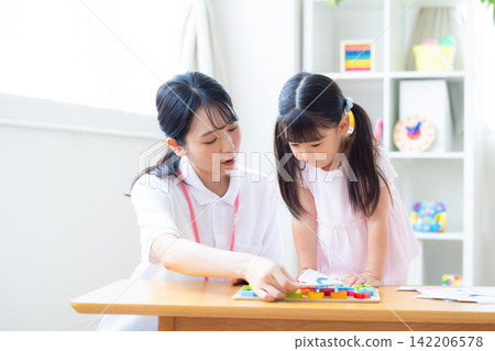 Early childhood education Girls taking lessons in an English conversation class Early childhood education Girls taking lessons in an English conversation class 142206578