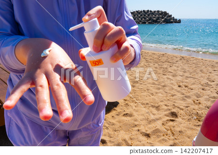 SPF, hands and girl on beach, sand and skincare for summer holiday in Korea SPF, hands and girl on beach, sand and skincare for summer holiday in Korea 142207417