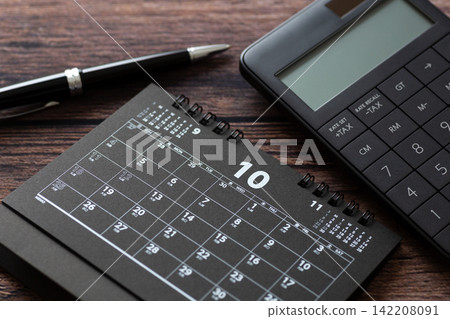 October calendar and black calculator October calendar and black calculator 142208091