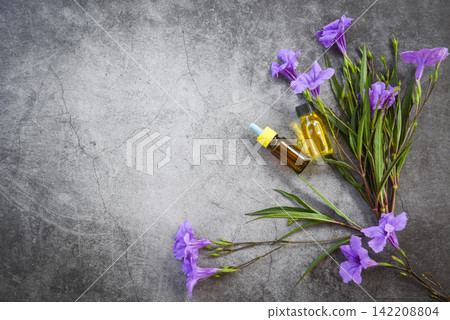 Aromatherapy herbal oil bottles aroma with flower leaves herbal formulations including wildflowers and herbs top view / Essential oils natural and green leaf organic Aromatherapy herbal oil bottles aroma with flower leaves herbal formulations including wildflowers and herbs top view / Essential oils natural and green leaf organic 142208804