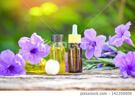 Aromatherapy herbal oil bottles aroma with flower purple on nature green background - Essential oils natural for face and body beauty remedies on wooden table and organic minimalist lifestyle Aromatherapy herbal oil bottles aroma with flower purple on nature green background - Essential oils natural for face and body beauty remedies on wooden table and organic minimalist lifestyle 142208806