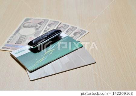 Bank passbook, seal, and 10,000 yen bill Bank passbook, seal, and 10,000 yen bill 142209168