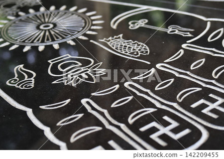 The footprints of Buddha drawn on a black, mirror-like stone. The footprints of Buddha drawn on a black, mirror-like stone. 142209455