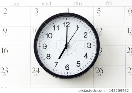 A clock and calendar showing 7 o'clock A clock and calendar showing 7 o'clock 142209482
