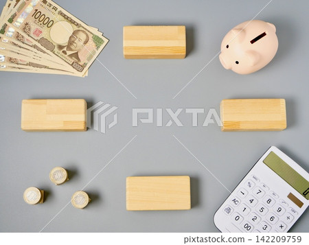 Calculator and piggy bank, wooden blocks, banknotes with lettering Calculator and piggy bank, wooden blocks, banknotes with lettering 142209759
