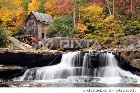 Autumn Waterfall and Rustic Grist Mill in Colorful Forest 142210533