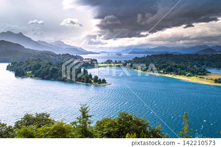 Dramatic Mountain Lake Landscape with Storm Clouds and Forest Dramatic Mountain Lake Landscape with Storm Clouds and Forest 142210573