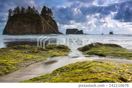 Rocky Ocean Beach with Sea Stacks and Dramatic Cloudy Sky 142210676