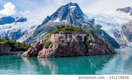 Glacier Mountain Landscape with Turquoise Fjord and Rocky Island 142210698