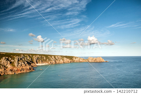 Rocky Coastline with Blue Ocean, Cliffs, and Cloudy Sky Rocky Coastline with Blue Ocean, Cliffs, and Cloudy Sky 142210712