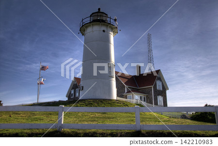 Coastal Lighthouse with American Flag and Historic Keeper House Coastal Lighthouse with American Flag and Historic Keeper House 142210983