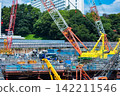 A crane at a construction site in an urban area [Construction image] 142211546