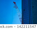 A crane at a construction site in an urban area [Construction image] 142211547