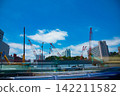 A crane at a construction site in an urban area [Construction image] 142211582