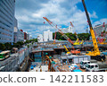 A crane at a construction site in an urban area [Construction image] 142211583