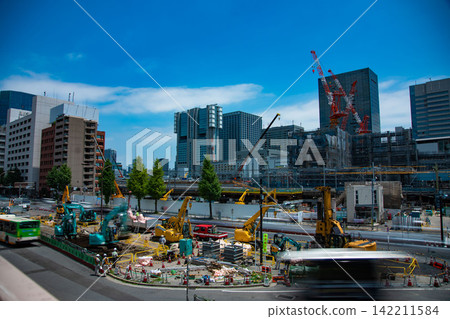 A crane at a construction site in an urban area [Construction image] 142211584