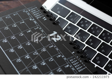 A black calendar and a computer for December A black calendar and a computer for December 142211973