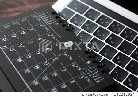 A black calendar and computer for August A black calendar and computer for August 142212924