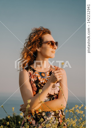 Woman flowers sunglasses outdoors posing in golden hour light with floral dress and peaceful summer atmosphere in meadow nature setting Woman flowers sunglasses outdoors posing in golden hour light with floral dress and peaceful summer atmosphere in meadow nature setting 142212941