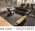 Dumbbells and bench press at the gym 142213035