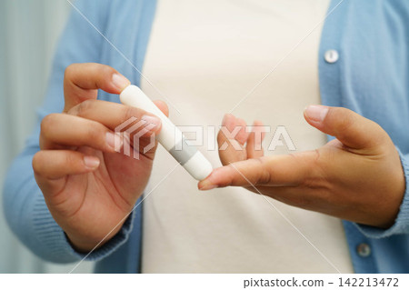 Asian woman injecting herself diabetes injecting insulin in stomach at home. Asian woman injecting herself diabetes injecting insulin in stomach at home. 142213472