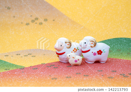 New Year's card design for the Year of the Sheep: A cute mother and baby white sheep relaxing in the fields and mountains. 142213793