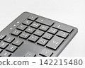 Numeric keypad of a computer keyboard, closeup on white. 142215480