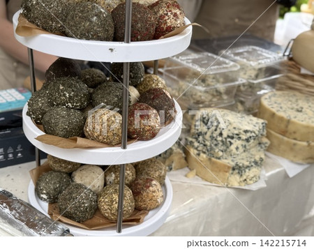 Variety of artisan cheeses on a display stand at a farmers market with copy space for text Variety of artisan cheeses on a display stand at a farmers market with copy space for text 142215714