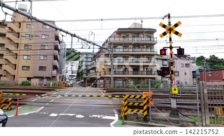 Japanese Railway Crossing with Tracks, Warning Signals and Urban Buildings Japanese Railway Crossing with Tracks, Warning Signals and Urban Buildings 142215752