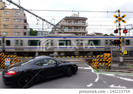 Japanese Railway Crossing with Tracks, Warning Signals and Urban Buildings Japanese Railway Crossing with Tracks, Warning Signals and Urban Buildings 142215754