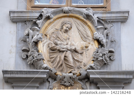 Virgin Mary with baby Jesus, statue on the house facade in Graz, Styria, Austria Virgin Mary with baby Jesus, statue on the house facade in Graz, Styria, Austria 142216248